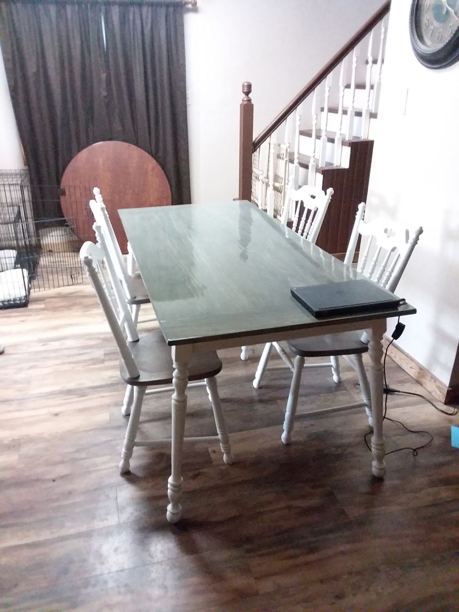 Finished farmhouse table with a soft grey-green stain