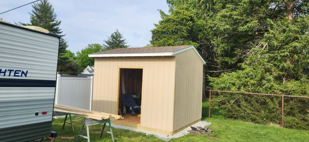 Newly built backyard shed with roof and siding on